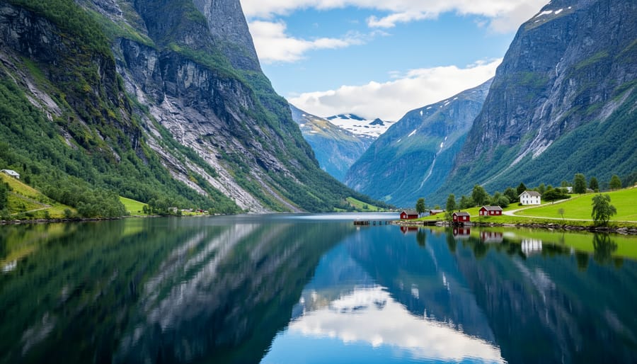 Dramatic view of Nærøyfjord's steep cliffs rising from calm water with ferry boat