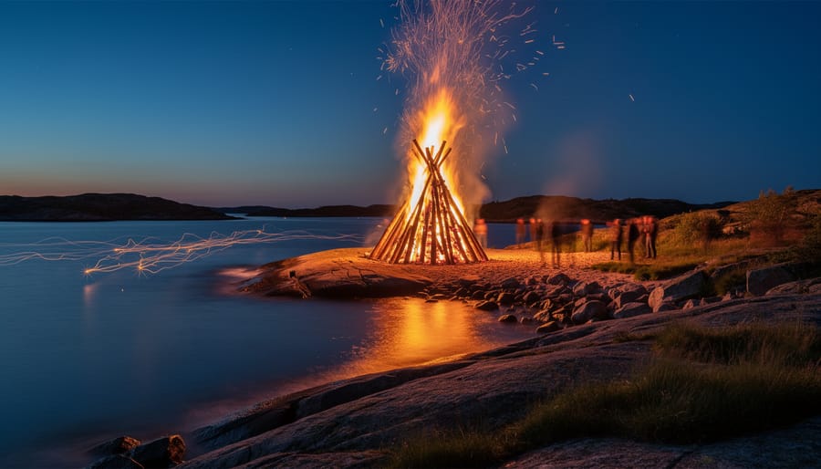 People gather around a St. Hans bonfire on the Norwegian coast with sparks and reflections on the water